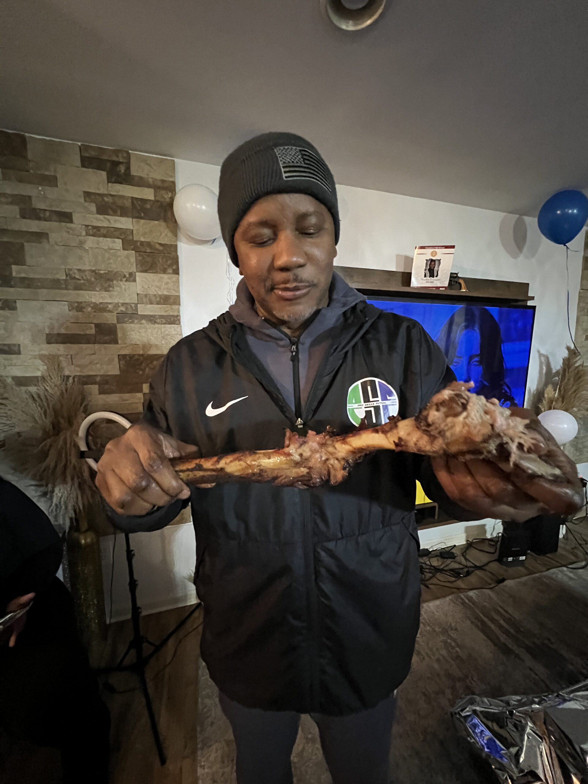Quam Dickson-Olaogun hoisted a large piece of roasted meat at Awwal Ayinde birthday party